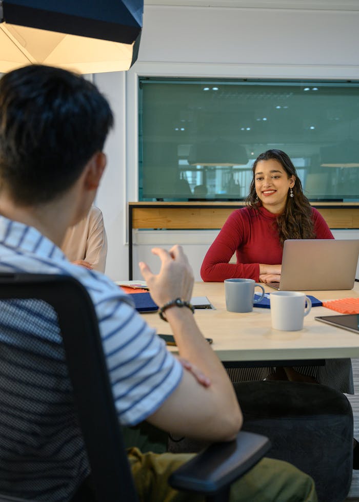 Group of diverse coworkers discussing projects in a modern office setting.